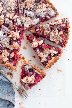 a piece of pie with powdered sugar on top and one slice missing from it