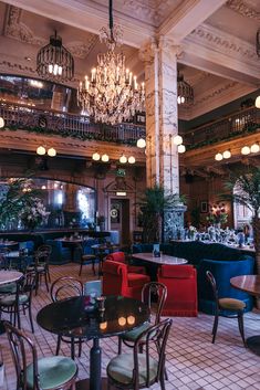 an ornately decorated restaurant with chandeliers and tables