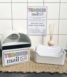 a mailbox and box on a table in front of a sign that says teacher mail