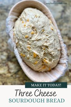 a loaf of bread sitting on top of a counter next to a bag with the words make it today three cheese sourdough bread