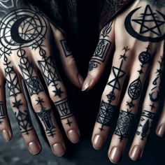 a person's hands with tattoos on them