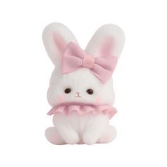 a white stuffed animal with a pink bow on it's head, sitting in front of a white background