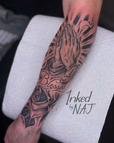 a person with a tattoo on their arm and hand in the middle of his forearm