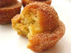 some sugared doughnuts on a white plate