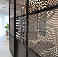 an office with metal partitions on the wall