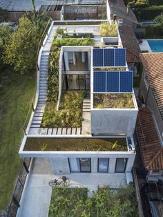 an aerial view of a house with solar panels on the roof