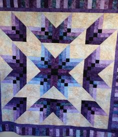 a purple and black quilt with squares on it