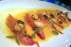 a white plate topped with food and garnishes on top of a table