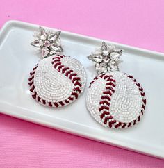 Score a home run in style with our dazzling Glitz Beaded Baseball Earrings! Perfect for baseball moms and fans alike, these earrings are the ultimate accessory for showing off your team spirit in glamorous fashion. Crafted with precision and attention to detail, each earring features intricate beading that resembles the iconic stitching of a baseball. The addition of sparkling rhinestones adds a touch of glitz and glamour, ensuring you stand out from the crowd whether you're cheering from the stands or celebrating after a big win. As baseball season heats up, these earrings are the perfect way to show your love for the game. Whether you're heading to the ballpark to watch your favorite team or hosting a World Series viewing party at home, these earrings are sure to be a hit. Designed with Sports Earrings, Baseball Jewelry, Baseball Earrings, Mom Earrings, Glamorous Fashion, Intricate Beading, Glitz And Glamour, Baseball Design, Earrings Summer