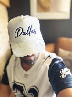 Dallas Hat, D-Town Trucker Hat, Texas Hat, Big D Hat, Cowboy Hat, Football Hat, Gift For Her, White/Navy  Embroidered Foam Trucker Hat Stand out from the crowd with this trendy foam trucker hat! This head accessory is made with high-quality polyester and foam that guarantees a premium look and feel. The foam trucker hat has an adjustable snap that ensures a comfortable fit, and the mesh back provides great breathability. The matching color braid gives the hat an extra oomph. Style it with your f White Flat Bill Trucker Hat For Baseball Season, White Snapback Trucker Hat With Letter Embroidery, White Trucker Hat With Letter Embroidery And Adjustable Fit, Adjustable White Trucker Hat With Letter Embroidery, White Adjustable Trucker Hat With Letter Embroidery, White Snapback Baseball Cap With Letter Embroidery, Adjustable White Baseball Cap With Letter Embroidery, White Letter Print Dad Hat For Baseball Season, White Adjustable Fitted Hat With Letter Print