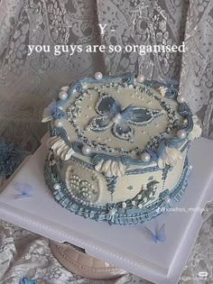 there is a cake that has been decorated with blue and white decorations