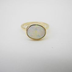 Opal Ring Elegant Opal Rings With Polished Finish, Elegant Opal Ring With Polished Finish, Elegant Oval Opal Ring With Polished Finish, Modern 14k Gold Oval Opal Ring, Modern White 14k Gold Ring, Polished Yellow Gold Opal Ring, Elegant Polished Opal Open Ring, Elegant Opal Open Ring With Polished Finish, Stackable 14k Gold Opal Ring