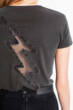 the back of a woman's t - shirt with sequins on it