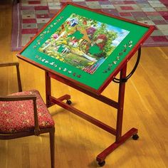 a green easel sitting on top of a hard wood floor next to a chair