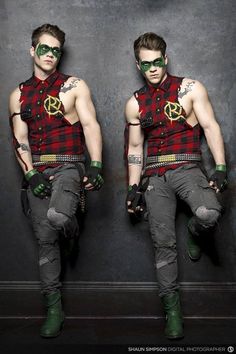 two young men dressed in punk clothing and green eyeglasses, one with the peace sign on his chest