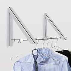 a shirt and tie are hanging on a clothes rack with four hangers attached to it