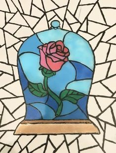 a stained glass window with a rose on it