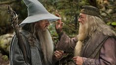 two men with long hair and beards talking to each other in front of trees