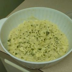 a white bowl filled with food sitting on top of a counter