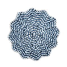 a blue and white circular rug on a white background