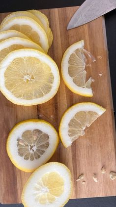 sliced up lemons sitting on top of a cutting board