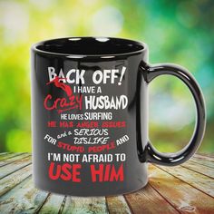 a black coffee mug with the words back off i have a crazy husband on it