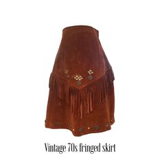 What a fun vintage western find! I am always looking for it and rarely find it. This 70's fringed cowgirl skirt is made of brown suede adorned with brass pieces. Heavy metal zipper on the side for closure. Add you some cowgirl boots and you are good to go! Excellent vintage condition. Approximately a modern size small but please check measurements.  Measurements: Waist: 25" Hips: free Length: 24" Skirt Png, Cowgirl Skirt, Western Skirts, Cowgirl Rodeo, Vintage Western, Metal Zipper, Cowgirl Boots, Brown Suede, Vintage 70s