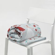 a white chair with a blanket on top of it