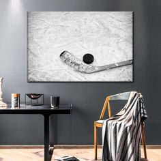 an ice hockey stick and puck in the middle of a room with a table, chair, and lamp