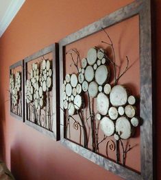 three pieces of wood are hanging on the wall next to each other in this living room