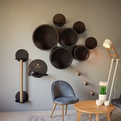 a living room filled with furniture next to a wall mounted disc art piece on the wall