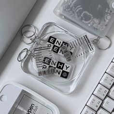 a keychain sitting on top of a computer keyboard next to a plastic bag