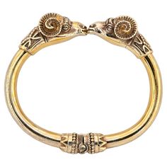 Past Marvels Revealed This outstanding antique Ram’s head bangle is a fine representation of the Etruscan revival made during 1880 ca It has been hand crafted of solid 18 KT gold with 50.00 grams weight Superb realistically done, like the real ones, two large Ram’s head meet face to face at the middle of the bangle, highly detailed in all aspects – granulation works and ancient geometries adorn the back heads and the hinged sides of the bangle, simply surprisingly beautiful throughout Etruscan j Etruscan Jewelry, Rams Head, Ram Head, Modern Life, Bangle Bracelets, Jewelry Bracelets, Hand Crafted, Bangles, Gems