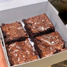 brownies in a box being held by someone's hand