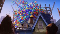 there are many balloons on the roof of this house and it looks like they're floating in the air