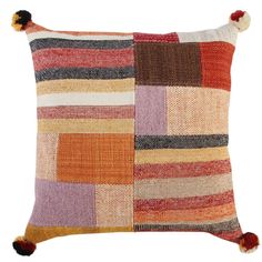 a multicolored pillow with pom poms