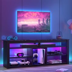 an entertainment center with a large television mounted on the wall and purple lighting behind it