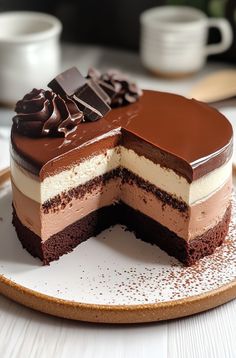 a chocolate and cream cake on a plate with one slice missing from the rest of the cake