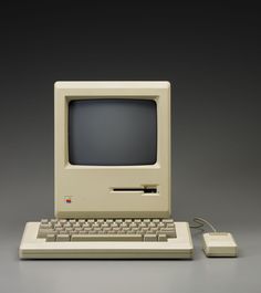 an old apple computer sitting on top of a table