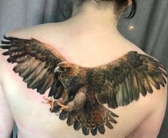 a woman with an eagle tattoo on her back