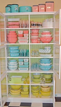 the shelves are filled with colorful dishes and bowls