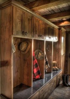 a room with some wooden cabinets and hats on it