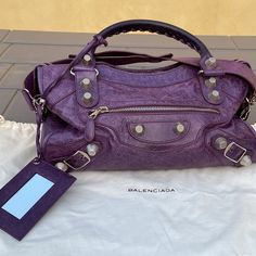 Balenciaga Authentic City Bag Made In Italy Purple Leather Chrome Hardware Mirror Zippered Closure Zippered Pockets Dust Bag Measurements 15” By 10” By 6” Deep Approximate Measurements Double Handles Long Shoulder Strap Clean Minimal Use Hard To Find All Photos Are Part Of The Description Vintage Balenciaga City Bag, Designer Purple Top Handle Shoulder Bag, Luxury Purple Shoulder Bag With Silver-tone Hardware, Designer Purple Shoulder Bag With Detachable Handle, Designer Purple Travel Bag, Designer Purple Top Handle Satchel, Designer Purple Bags, Luxury Purple Bag With Branded Hardware, Luxury Purple Satchel With Top Carry Handle