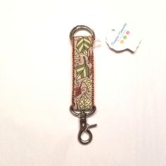 a keychain with an animal design on it and a tag attached to it