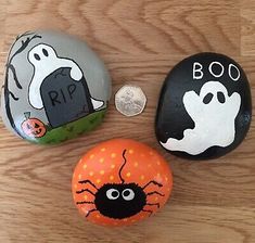 three painted rocks with halloween decorations on them