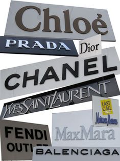 many signs are stacked on top of each other in different languages and sizes, including one for the word'chanel '