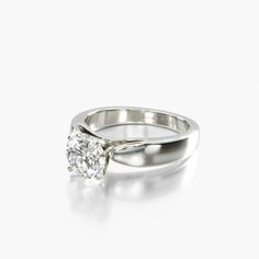 a white gold ring with a single diamond in the center, on a white background