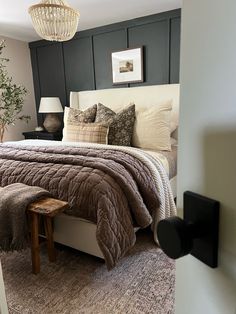 a bedroom with a large bed and pillows on it's headboard is shown