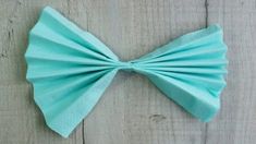 a light blue bow tie sitting on top of a wooden table