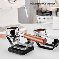 two coffee grinders sitting next to each other on top of a white countertop